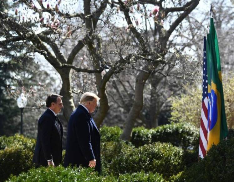 US President Donald Trump and Brazil's President Jair Bolsonaro (L) leave after a press conference in the Rose Garden at the White House on March 19, 2019 in Washington, DC. (Photo by Brendan Smialowski / AFP)