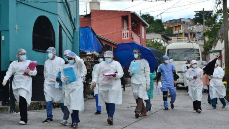Personal de la Secretaría de Salud visitó diferentes sectores de la periferia norte de Tegucigalpa durante una campaña para combatir el dengue en medio de la pandemia. AFP
