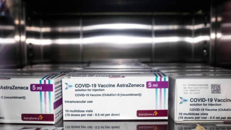 Boxes containing vials of the AstraZeneca Covid-19 vaccine are pictured at the pharmacy of the Sant'Andrea hospital in Vercelli, Piedmont, on April 15, 2021. (Photo by MARCO BERTORELLO / AFP)