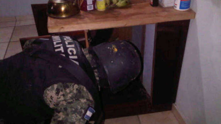 En la cocina de una de las casas allanadas se encontó un túnel secreto, dentro de él varios sacos que escondían un fusil R 15.