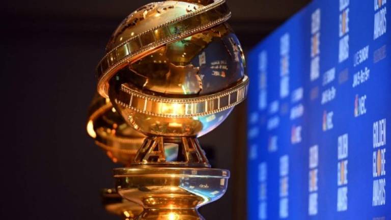 (FILES) In this file photo Golden Globe statues are set by the stage ahead of the 77th Annual Golden Globe Awards nominations announcement in Beverly Hills on December 9, 2019. - Hollywood's award season kicks off February 28, 2021 at a very different Golden Globes, with a mainly virtual ceremony set to boost or dash the Oscars hopes of early frontrunners like 'Nomadland' and 'The Trial of the Chicago 7.' Usually a star-packed, laid-back party that draws Tinseltown's biggest names to a Beverly Hills hotel ballroom, this pandemic edition will be broadcast from two scaled-down venues in California and New York, with frontline and essential workers among the few in attendance. (Photo by Robyn BECK / AFP)