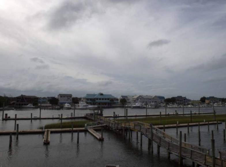 Houses are seen on the waters edge near Wrightsville beach in Wilmington, North Carolina on September 13, 2018.<br/>Hurricane Florence edged closer to the east coast of the US Thursday, with tropical-force winds and rain already lashing barrier islands just off the North Carolina mainland. The huge storm weakened to a Category 2 hurricane overnight, but forecasters warned that it still packed a dangerous punch, 110 mile-an-hour (175 kph) winds and torrential rains. / AFP PHOTO / ANDREW CABALLERO-REYNOLDS