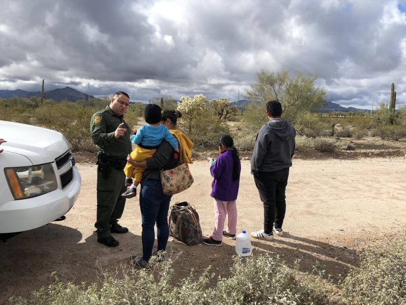 Agente de la patrulla fronteriza habla con una inmigrante hondureña junto a sus tres hijos de 2, 9 y 14 años en la frontera de Arizona con México.