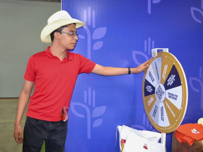 Un cliente gira la ruleta para conocer qué regalo recibirá por su compra en el stand de la empresa.