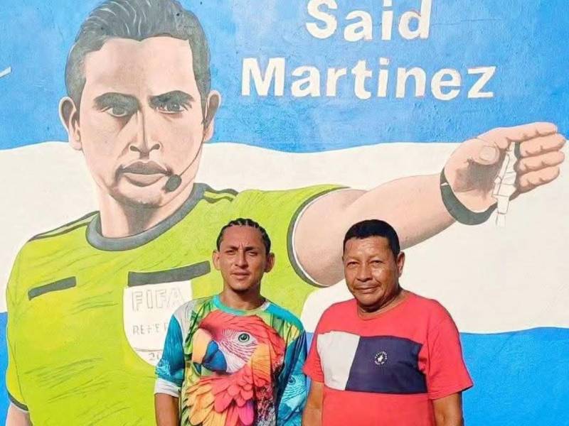 El artista César Orellana junto al padre del árbitro hondureño Said Martínez.