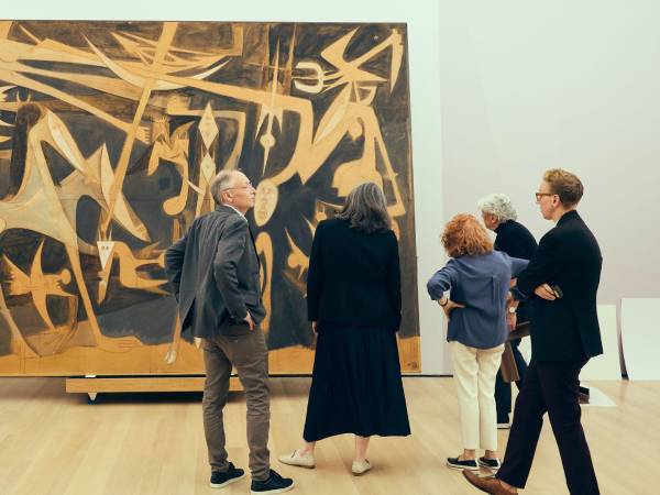 Christophe Cherix (izq.) junto a Beverly Adams (centro) instalando “Grande Composition” de Wifredo Lam.