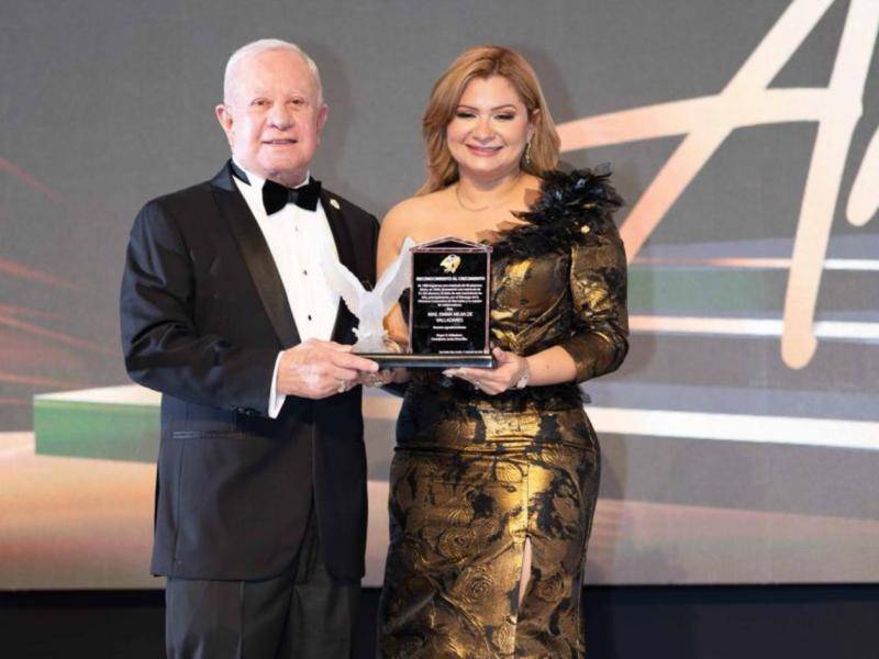 Roger D. Valladares entregando el reconocimiento a Emma Mejía de Valladares.