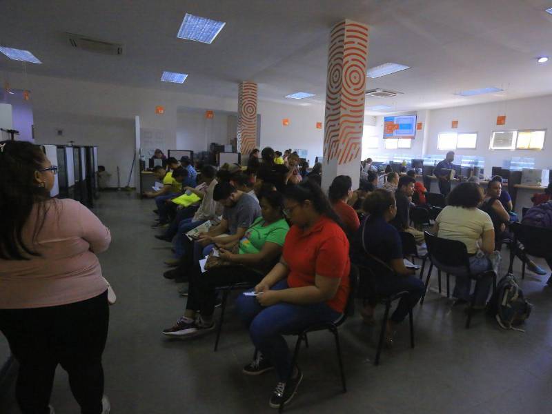 Hondureños esperan su turno en la oficina principal del RNP en San Pedro Sula.