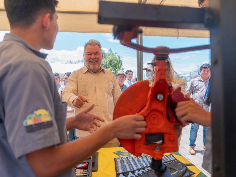 El alcalde Roberto Contreras observa a estudiantes manipulando equipo en uno de los centros técnicos.