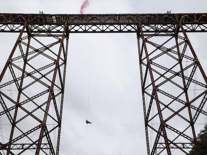 El mayor de los Bomberos Municipales, Héctor Chacón, participa en su tradicional salto, alrededor de 70 metros de altura desde el “Puente de las Vacas” este domingo, en Ciudad de Guatemala (Guatemala). EFE