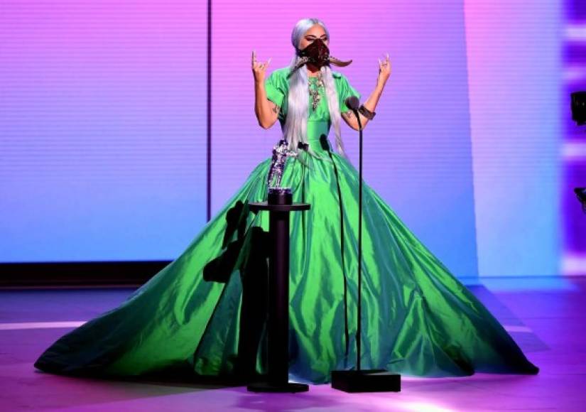 Durante los VMAs, la intérprete de 'Bad Romance' también sorprendió con un maxivestido en color verde esmeralda y una mascarilla con un diseño único.