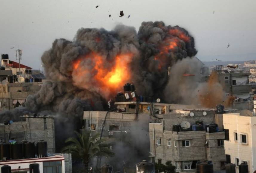 Una bola de fuego surge de un edificio en el distrito residencial Rimal de la ciudad de Gaza el 16 de mayo de 2021, durante el bombardeo masivo israelí en el enclave controlado por Hamas. (Foto de Bashar TALEB / AFP)