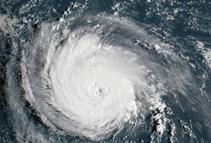 This NOAA/RAMMB satellite image taken at 11:30 UTC on September 11, 2018, shows Hurricane Florence off the US east coast in the Atantic Ocean.<br/><br/>Powerful Hurricane Florence headed toward the US East Coast Tuesday, prompting authorities to order more than a million people to evacuate the path of the extremely dangerous storm forecasters said could soon intensify. Residents scrambled to flee as the menacing Category 4 storm packing winds of 140 miles (220 kilometers) per hour moved closer.'This is one of the worst storms to hit the East Coast in many years,' President Donald Trump warned on Twitter. 'Please be prepared, be careful and be SAFE!'<br/> / AFP PHOTO / NOAA/RAMMB / HO / RESTRICTED TO EDITORIAL USE - MANDATORY CREDIT 'AFP PHOTO / NOAA/RAMMB' - NO MARKETING NO ADVERTISING CAMPAIGNS - DISTRIBUTED AS A SERVICE TO CLIENTS<br/><br/>