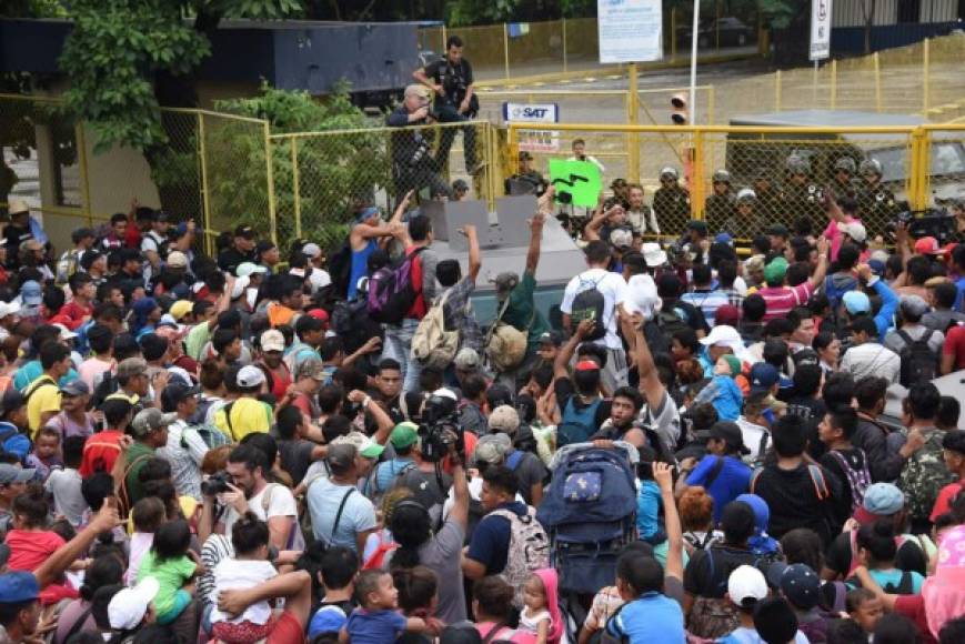 Los hondureños superaron una barrera de decenas de policías antidisturbios y militares que se apostaron con vehículos blindados. Foto AFP