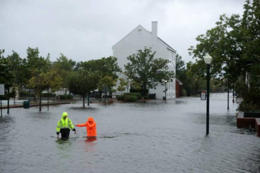 NEW BERN, NC - SEPTEMBER 13: Residents walk in flooded streets as the Neuse River floods its banks during Hurricane Florence September 13, 2018 in New Bern, North Carolina. Coastal cities in North Carolina, South Carolina and Virginia are under evacuation orders as the Category 2 hurricane approaches the United States. Chip Somodevilla/Getty Images/AFP
