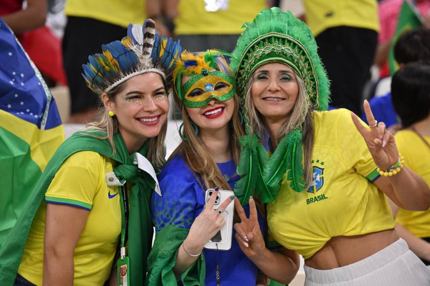 Aficionadas brasileñas con máscaras e indumentaria representativa de la Canarinha. 
