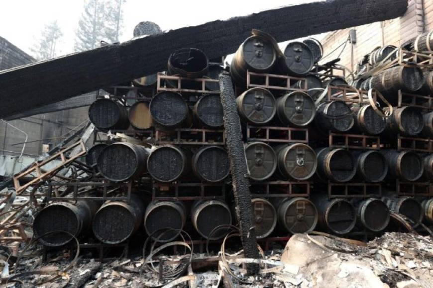 CALISTOGA, CALIFORNIA - SEPTEMBER 29: Damaged wine barrels sit stacked at Fairwinds Estate Winery that was destroyed by the Glass Fire on September 29, 2020 in Calistoga, California. The fast moving Glass Incident Fire, originally called the Glass Fire, has burned over 36,000 acres in Sonoma and Calistoga counties and has destroyed numerous wineries and structures. The fire is zero percent contained. Justin Sullivan/Getty Images/AFP<br/><br/>== FOR NEWSPAPERS, INTERNET, TELCOS & TELEVISION USE ONLY ==<br/><br/>