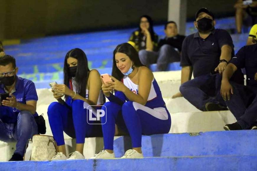 Estas dos bellezas estaban entretenidas con sus celulares durante el juego Real España-UPN.