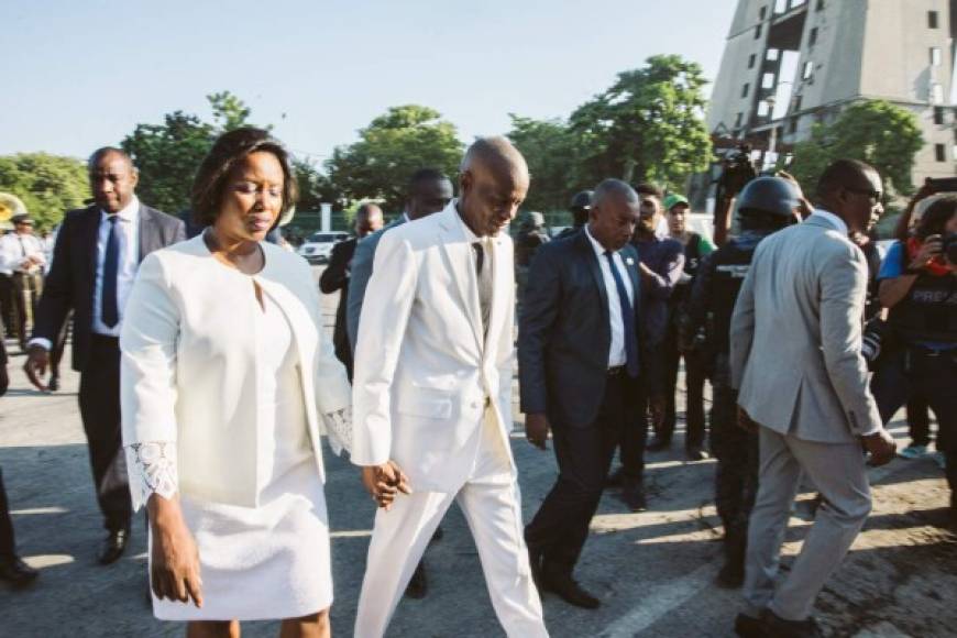 (FILES) In this file photo Haitian President Jovenel Moises (C), with his wife Martine Étienne Joseph (L), leaves a ceremony marking the assassination of Jean-Jacques Dessalines, leader of the Haitian Revolution and the first ruler of an independent Haiti, Port-au-Prince on October 17, 2019. - Haiti President Jovenel Moise was assassinated and his wife wounded early July 7, 2021 in an attack at their home, the interim prime minister announced, an act that risks further destabilizing the Caribbean nation beset by gang violence and political volatility. Claude Joseph said he was now in charge of the country and urged the public to remain calm, while insisting the police and army would ensure the population's safety. 'The president was assassinated at his home by foreigners who spoke English and Spanish,' Joseph said of the assault that took place around 1:00 am (0500 GMT) and left the president's wife hospitalized. (Photo by Valerie Baeriswyl / AFP)
