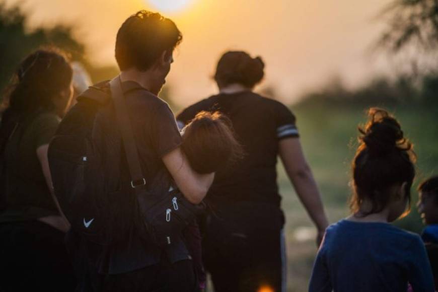 LA JOYA, TEXAS - JUNE 21: A migrant family waits to be accounted for and taken to a border patrol processing facility after crossing the Rio Grande into the U.S. on June 21, 2021 in La Joya, Texas. A surge of mostly Central American immigrants crossing into the United States has challenged U.S. immigration agencies along the U.S. Southern border. Brandon Bell/Getty Images/AFP<br/><br/>== FOR NEWSPAPERS, INTERNET, TELCOS & TELEVISION USE ONLY ==<br/><br/>