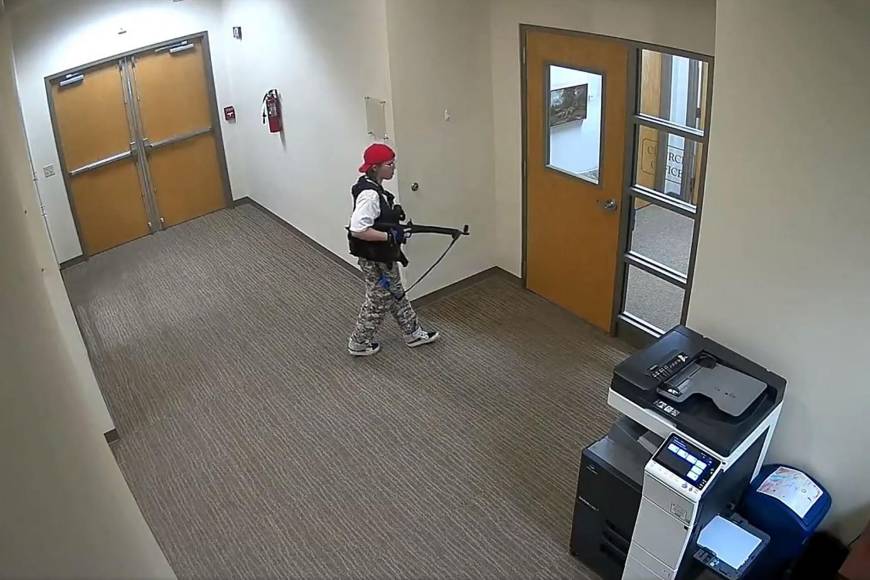 This handout video grab image courtesy of the Metropolitan Nashville Police Department released on March 27, 2023, shows suspect Audrey Hale holding an assault rifle at the Covenant School building at the Covenant Presbyterian Church, in Nashville, Tennessee. - A heavily armed former student killed three young children and three staff in what appeared to be a carefully planned attack at a private elementary school in Nashville on Monday, before being shot dead by police. Chief of Police John Drake named the suspect as Audrey Hale, 28, who the officer later said identified as transgender. (Photo by Metropolitan Nashville Police Department / AFP) / RESTRICTED TO EDITORIAL USE - MANDATORY CREDIT "AFP PHOTO / Metropolitan Nashville Police Department " - NO MARKETING - NO ADVERTISING CAMPAIGNS - DISTRIBUTED AS A SERVICE TO CLIENTS