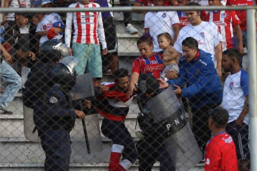 Un aficionado del Olimpia es detenido por la policía.