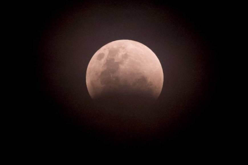 La luna se tiñó hoy de color rojizo debido a un eclipse lunar total que ocurrió además cuando el satélite se encuentra en el punto más cercano a la Tierra, un fenómeno seguido por millones de personas en medio mundo.