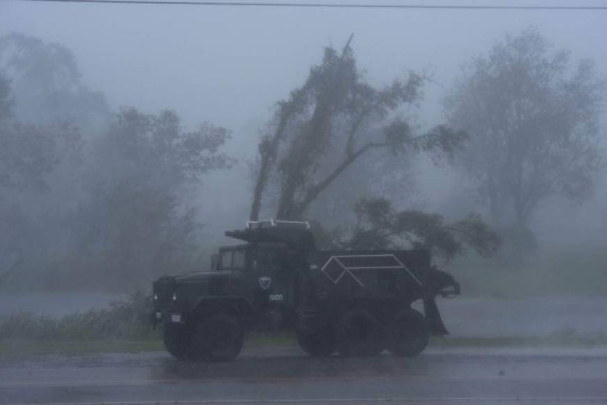A truck is seen in heavy winds and rain from hurricane Ida in Bourg, Louisiana on August 29, 2021. - Hurricane Ida struck the coast of Louisiana Sunday as a powerful Category 4 storm, 16 years to the day after deadly Hurricane Katrina devastated the southern US city of New Orleans.'Extremely dangerous Category 4 Hurricane Ida makes landfall near Port Fourchon, Louisiana,' the National Hurricane Center wrote in an advisory. (Photo by Mark Felix / AFP)