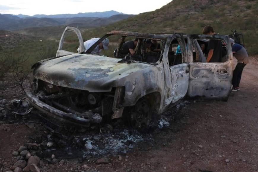 CORRECTION - Members of the Lebaron family watch the burned car where part of the nine murdered members of the family were killed and burned during an gunmen ambush on Bavispe, Sonora mountains, Mexico, on November 5, 2019. - US President Donald Trump offered Tuesday to help Mexico 'wage war' on its cartels after three women and six children from an American Mormon community were murdered in an area notorious for drug traffickers. (Photo by Herika MARTINEZ / AFP) / The erroneous mention[s] appearing in the metadata of this photo by Herika MARTINEZ has been modified in AFP systems in the following manner: [AFP PHOTO / Herika MARTINEZ ] instead of [AFP PHOTO / STR ]. Please immediately remove the erroneous mention[s] from all your online services and delete it (them) from your servers. If you have been authorized by AFP to distribute it (them) to third parties, please ensure that the same actions are carried out by them. Failure to promptly comply with these instructions will entail liability on your part for any continued or post notification usage. Therefore we thank you very much for all your attention and prompt action. We are sorry for the inconvenience this notification may cause and remain at your disposal for any further information you may require.