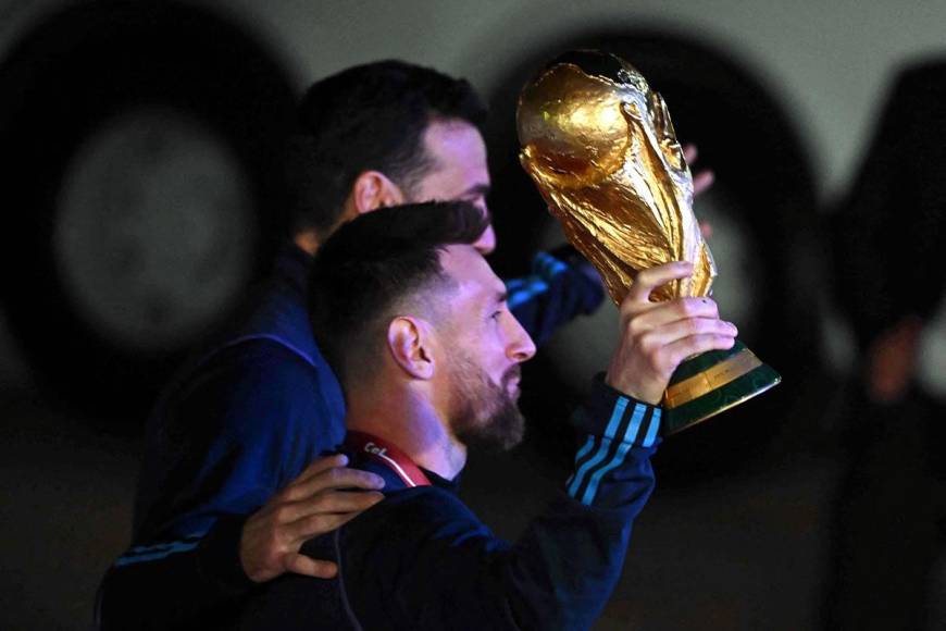 Lionel Messi levantando el trofeo dorado en su camino al autobús.