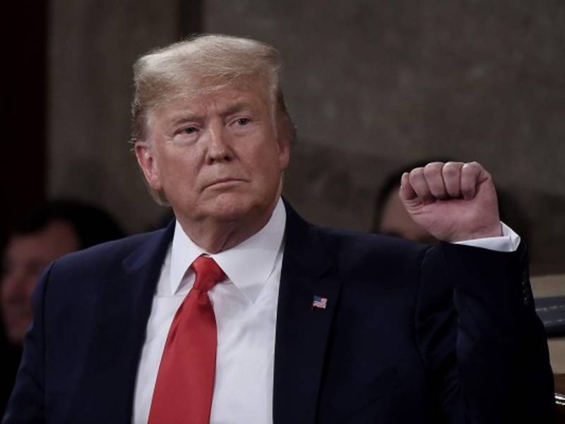 President Donald Trump pumps his fist as he delivers the State of the Union address in the chamber of the US House of Representatives at the US Capitol Building on February 4, 2020 in Washington, DC. (Photo by Olivier DOULIERY / AFP)
