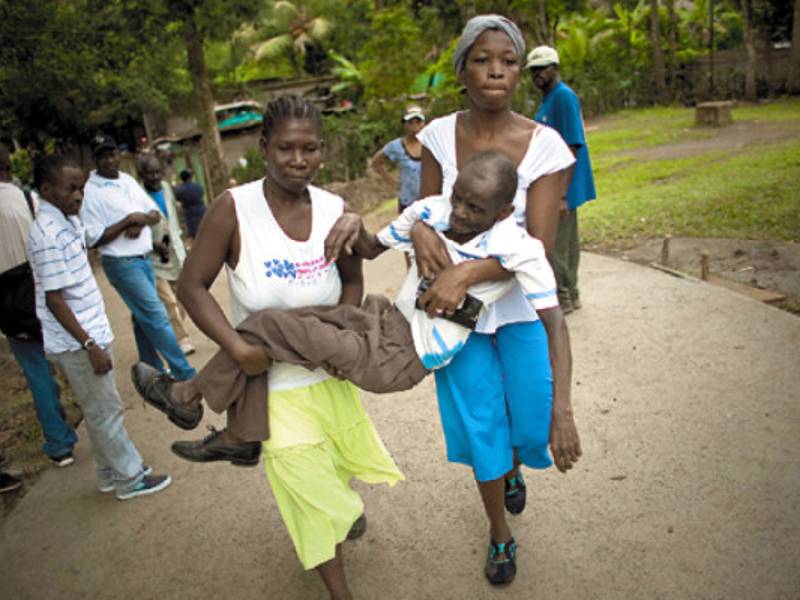 A man with cholera symptoms is carried to a public hospital in Limbe village near Cap Haitian, Haiti, Monday Nov. 22, 2010. Thousands of people have been hospitalized for cholera across Haiti with symptoms including serious diarrhea, vomiting and fever and at least 1,100 people have died. (AP photo/Emilio Morenatti)