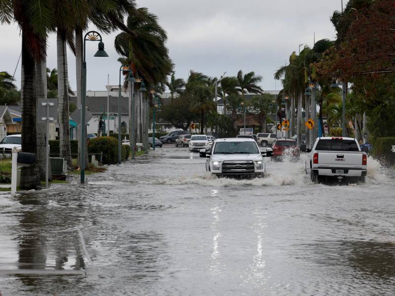 FORT PIERCE, FLORIDA - NOVEMBER 10: Vehicles drive through a flooded street after Hurricane Nicole came ashore on November 10, 2022 in Fort Pierce, Florida. Nicole came ashore as a Category 1 hurricane before hitting Florida’s east coast. Joe Raedle/Getty Images/AFP (Photo by JOE RAEDLE / GETTY IMAGES NORTH AMERICA / Getty Images via AFP)