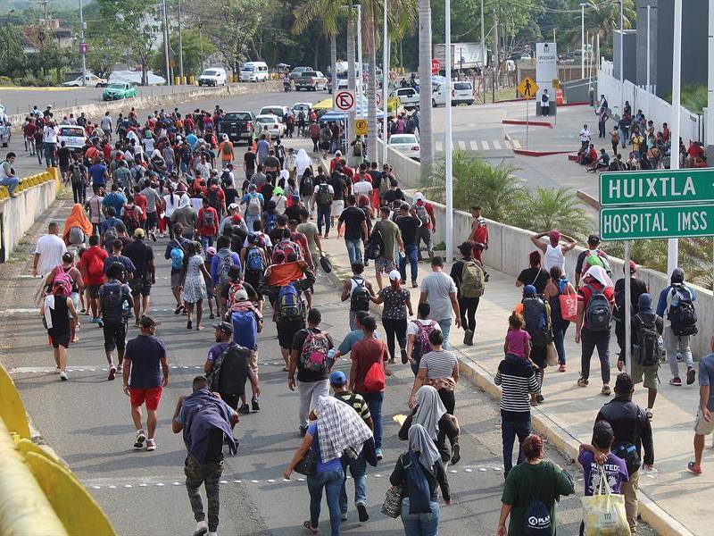 Migrantes de diferentes nacionalidades caminan en caravana pacíficamente hoy, por las principales avenidas de la ciudad de Tapachula en Chiapas .