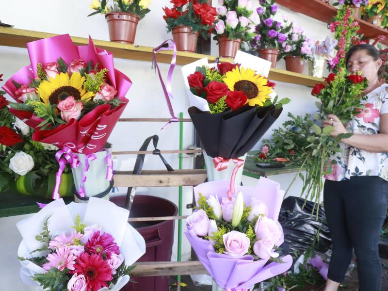 Una comerciante sampedrana muestra sus arreglos florales.