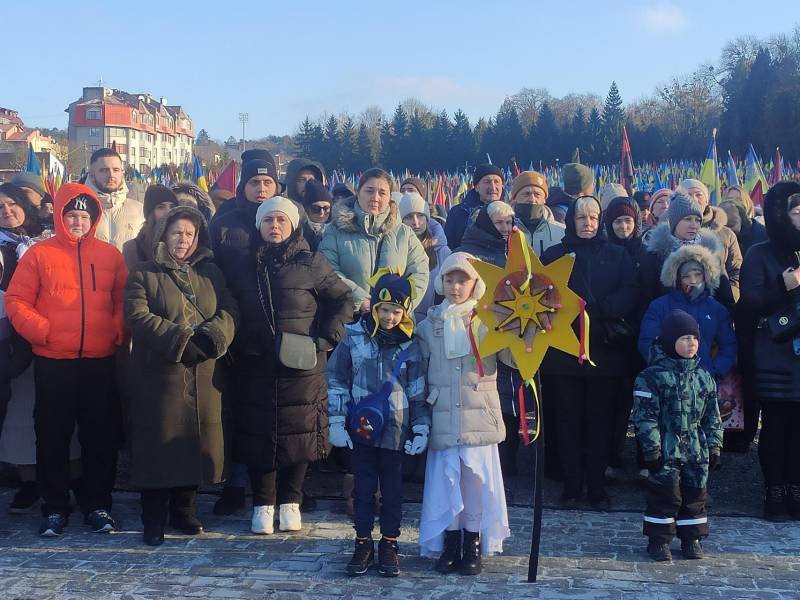 Familias de las personas ucranianas caídas este jueves durante la ceremonia del Villancico Triste en el Cementerio Militar de Leópolis (Ucrania).