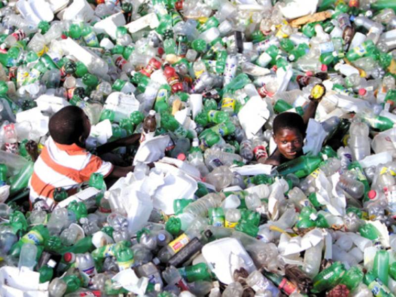Children look for mangos in a water canal full of garbage in Cap Haitian, Haiti, Friday, Nov. 19, 2010. Thousands of people have been hospitalized for cholera across Haiti with symptoms including serious diarrhea, vomiting and fever and at least 1,100 people have died. (AP Photo/Dieu Nalio Chery)