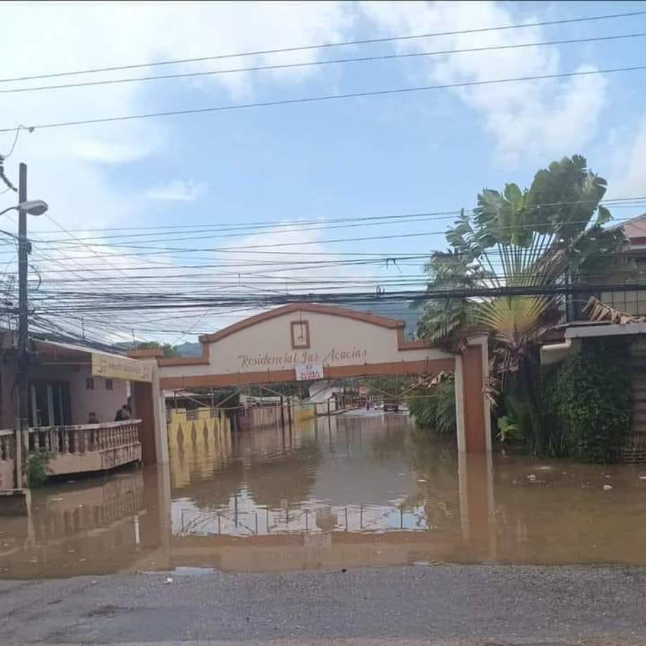 A eso de las 6:00 pm, cuando ya no llovía, el agua en la entrada a la residencial Las Acacias, seguían anegadas.