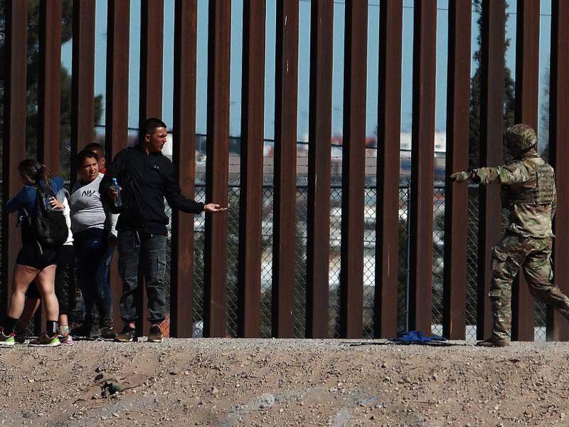 Integrantes de la Guardia Nacional de Estados Unidos impide el avance de migrantes que intentan cruzar la frontera con México en Ciudad Juárez (México).