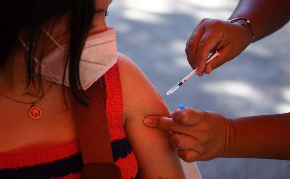 Una mujer es inoculada con la vacuna Pfizer-BioNTech contra la enfermedad del nuevo coronavirus en un centro de vacunación en Asunción.