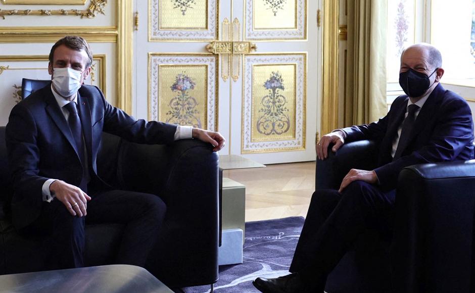 El presidente francés Emmanuel Macron conversa con el canciller alemán Olaf Scholz en el Palacio del Elíseo.