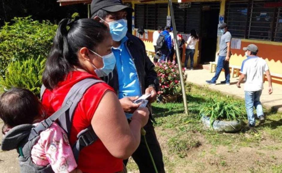 Cargó a su hija desde la casa hasta el centro de votación, pero cumplió. Esta dama llegó temprano al centro de votación en La Esperanza.