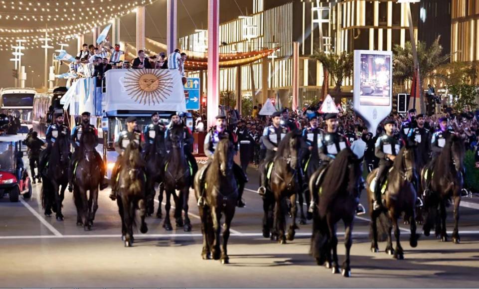 Los caballos de la policía de Qatar abren el paso al plantel argentino por las calles de Doha.