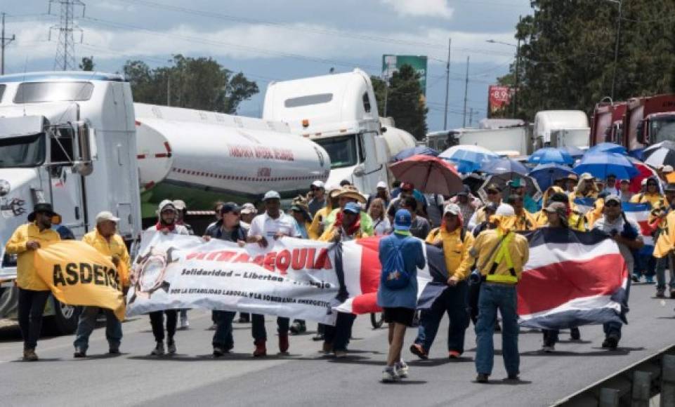 Workers of Costa Rican oil refinery Recope demonstrate outside a refinery in Cartago, Costa Rica, on September 19, 2018 during an indefinite strike called by the country's unions against a tax reform.<br/>The unions of the Costa Rican public sector began an indefinite strike on September 10, in opposition to a tax reform project which would mean an increase of taxes to face the bulky fiscal deficit. Due to the strike, gasoline is scarce in many gas stations across the country. / AFP PHOTO / Ezequiel BECERRA