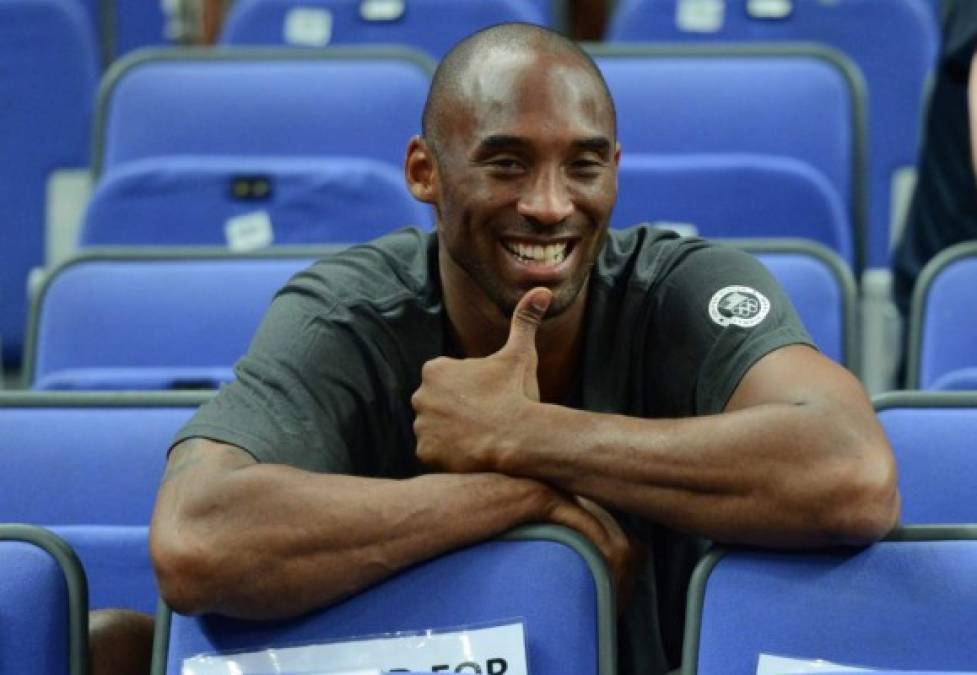 (FILES) In this file photo taken on August 11, 2012 US basketball player Kobe Bryant attends the London 2012 Olympic Games women's gold medal basketball game between the USA and France at the North Greenwich Arena in London. - NBA legend Kobe Bryant died Sunday in a helicopter crash in suburban Los Angeles, celebrity website TMZ reported, saying five people are confirmed dead in the incident. (Photo by Timothy A. CLARY / AFP)