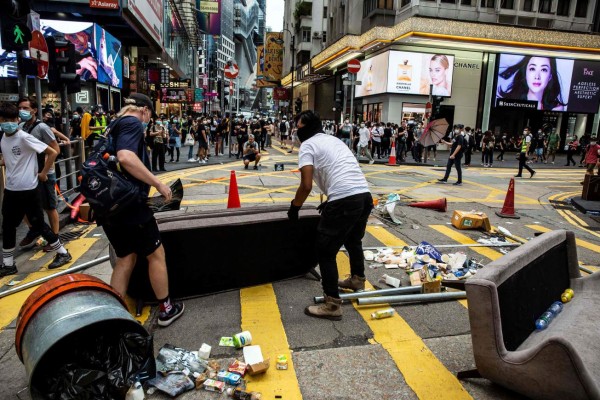 Pro-democracy protesters block roads in the Causeway Bay district of Hong Kong on May 24, 2020, ahead of planned protests against a proposal to enact new security legislation in Hong Kong. - The proposed legislation is expected to ban treason, subversion and sedition, and follows repeated warnings from Beijing that it will no longer tolerate dissent in Hong Kong, which was shaken by months of massive, sometimes violent anti-government protests last year. (Photo by ISAAC LAWRENCE / AFP)