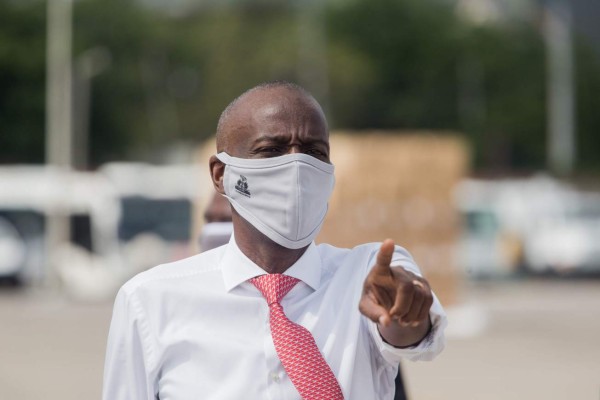 (FILES) In this file photo taken on May 7, 2020 Haitian President Jovenel Moise instructs staff members on the tarmac of Toussaint Louverture International Airport in Port-au-Prince, as coronavirus aid from China arrives in a cargo plane. - The United States on February 5, 2021 accepted unpopular Haitian President Jovenel Moise's claim to hold power for another year but urged restraint and fresh elections. (Photo by Pierre Michel Jean / AFP)