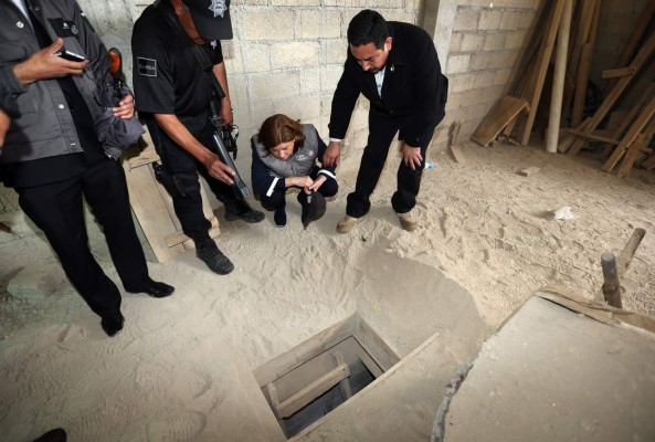 Handout picture released by the Attorney General of Mexico (PGR) showing Mexico's Attorney General, Arely Gomez (2-R) looking at the alleged end of the tunnel through which Mexican drug lord Joaquin 'El Chapo' Guzman could have escaped from the Altiplano prison, at a house in Almoloya de Juarez, Mexico, on July 12, 2015. Guzman has escaped from a maximum-security prison, the government said Sunday, his second jail break in 14 years. The kingpin was last seen in the shower area of the Altiplano prison in central Mexico late Saturday before disappearing. 'The escape of Guzman was confirmed', the National Security Commission said in a statement. AFP PHOTO / ATTORNEY GENERAL OF MEXICO / HO --- RESTRICTED TO EDITORIAL USE - MANDATORY CREDIT 'AFP PHOTO / ATTORNEY GENERAL OF MEXICO / HO' - NO MARKETING NO ADVERTISING CAMPAIGNS - DISTRIBUTED AS A SERVICE TO CLIENTS - GETTY OUT