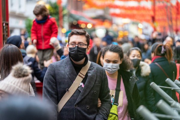 London, January 26, 2020. People wearing a face masks to protecting themself because of epidemic in China. Selective Focus. Concept of coronavirus quarantine. MERS-Cov, middle East respiratory syndrome coronavirus, Novel coronavirus 2019-nCoV.