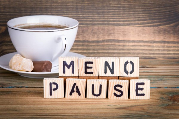 menopause. Wooden letters on the office desk, informative and communication background.